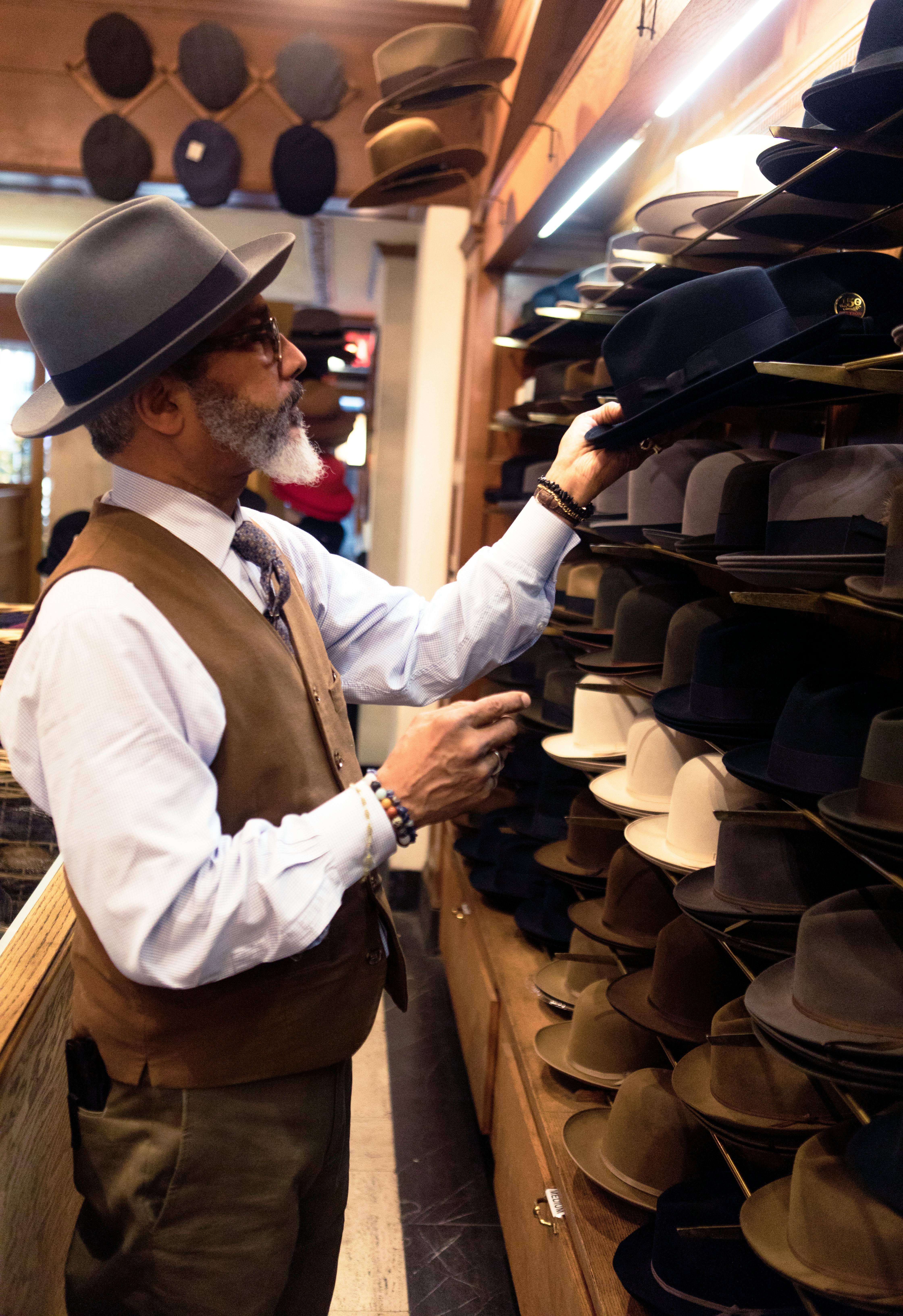 https://www.pexels.com/photo/man-picking-hats-in-rack-936038/