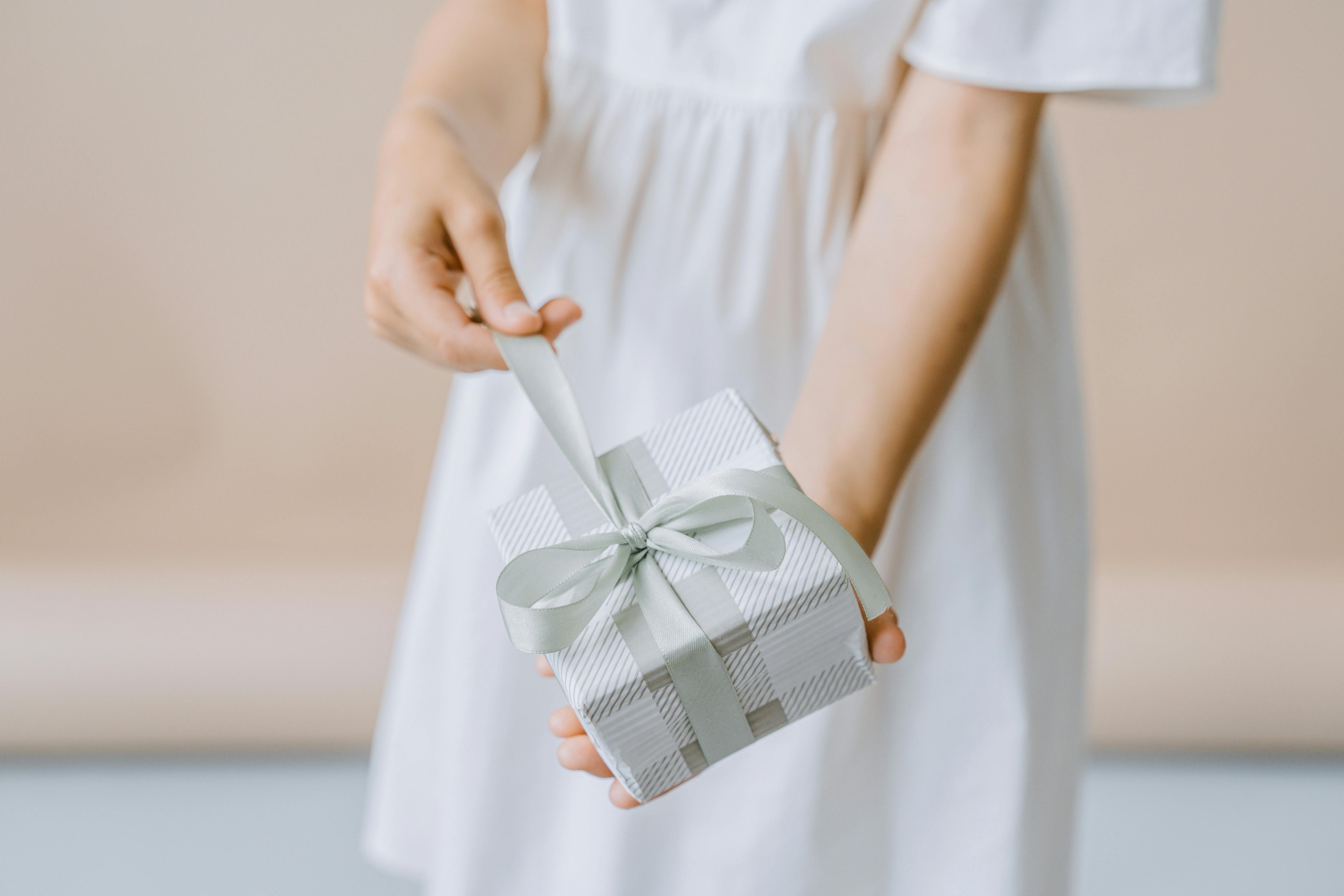 https://www.pexels.com/photo/a-person-holding-a-present-9628007/